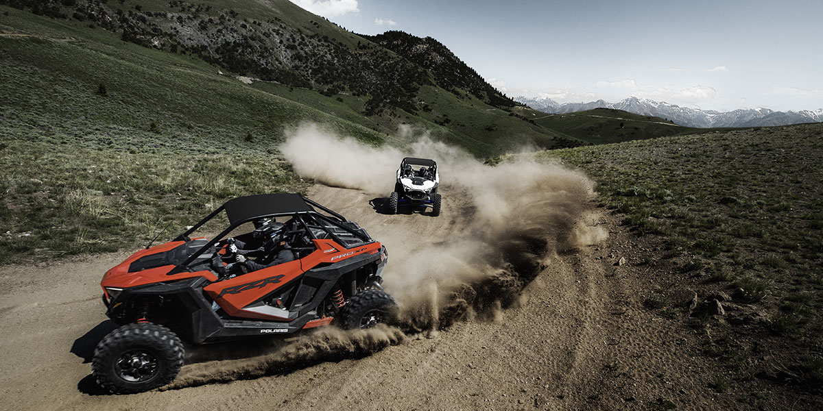 Two RZR's on dirt track